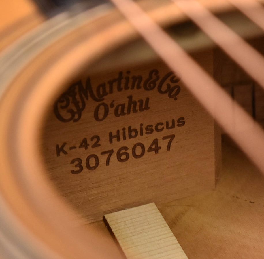 Martin O'ahu K-42 Hibiscus stamped text on a wooden component behind a circular grille