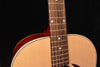 Acoustic-electric guitar neck and upper bout close-up with frets and soundhole