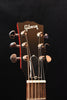 Natural guitar headstock with Gibson logo and six tuning pegs