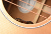 Guitar soundhole control labels showing 'vol' and 'tone' on light wood