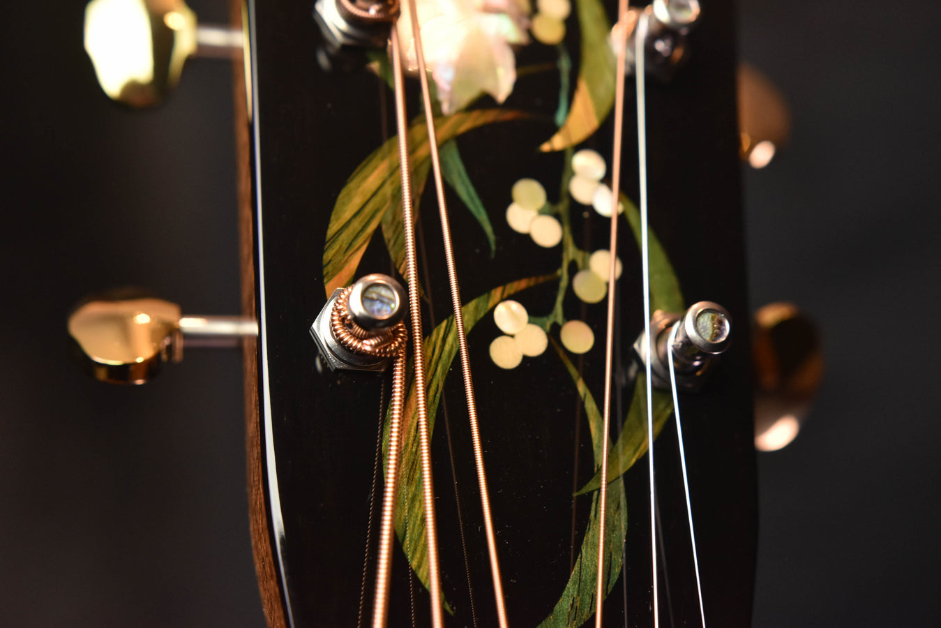 Acoustic guitar tuning gear detail with floral headstock inlay