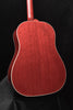 Red acoustic guitar front view with curved body and cream binding