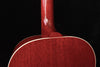 Red guitar body close-up with textured finish near the soundhole