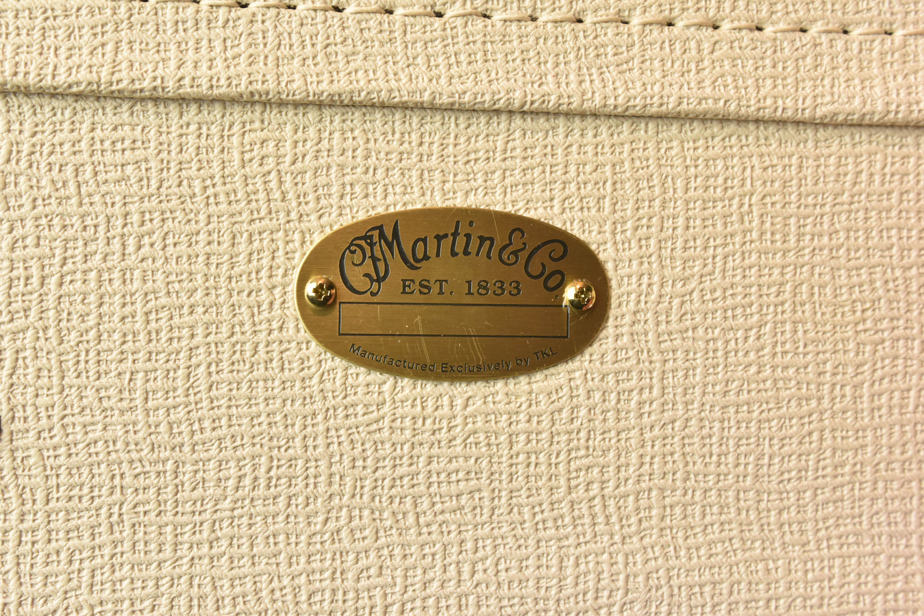 Martin logo badge on textured acoustic guitar finish