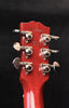 Red guitar headstock with tuning hardware and stamped number text