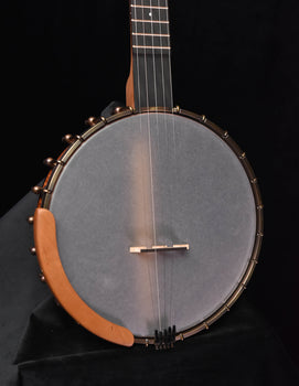 open-back banjo body with grey drumhead, bridge and wooden tone ring