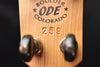 Headstock with 'Boulder ODE Colorado 259' text and metal tuning pegs