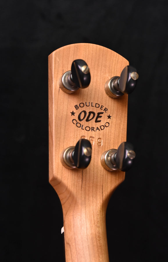 Banjo headstock with four black tuning pegs and 'Boulder ODE Colorado' logo