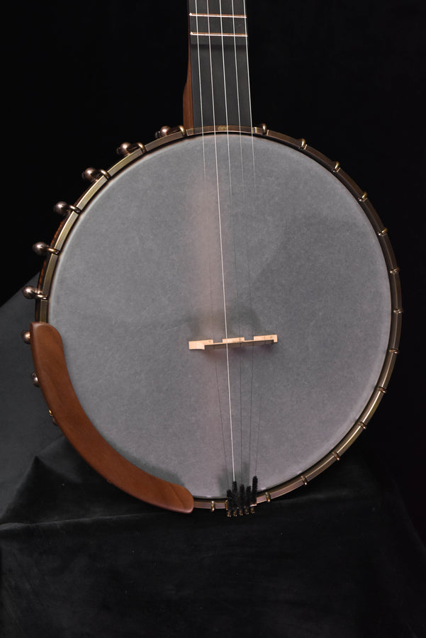 Open-back banjo front view with gray drumhead, metal hooks, and brown wooden rim