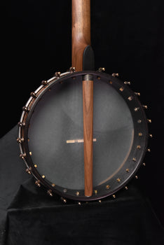 walnut neck across gray banjo drumhead with chrome rim hooks