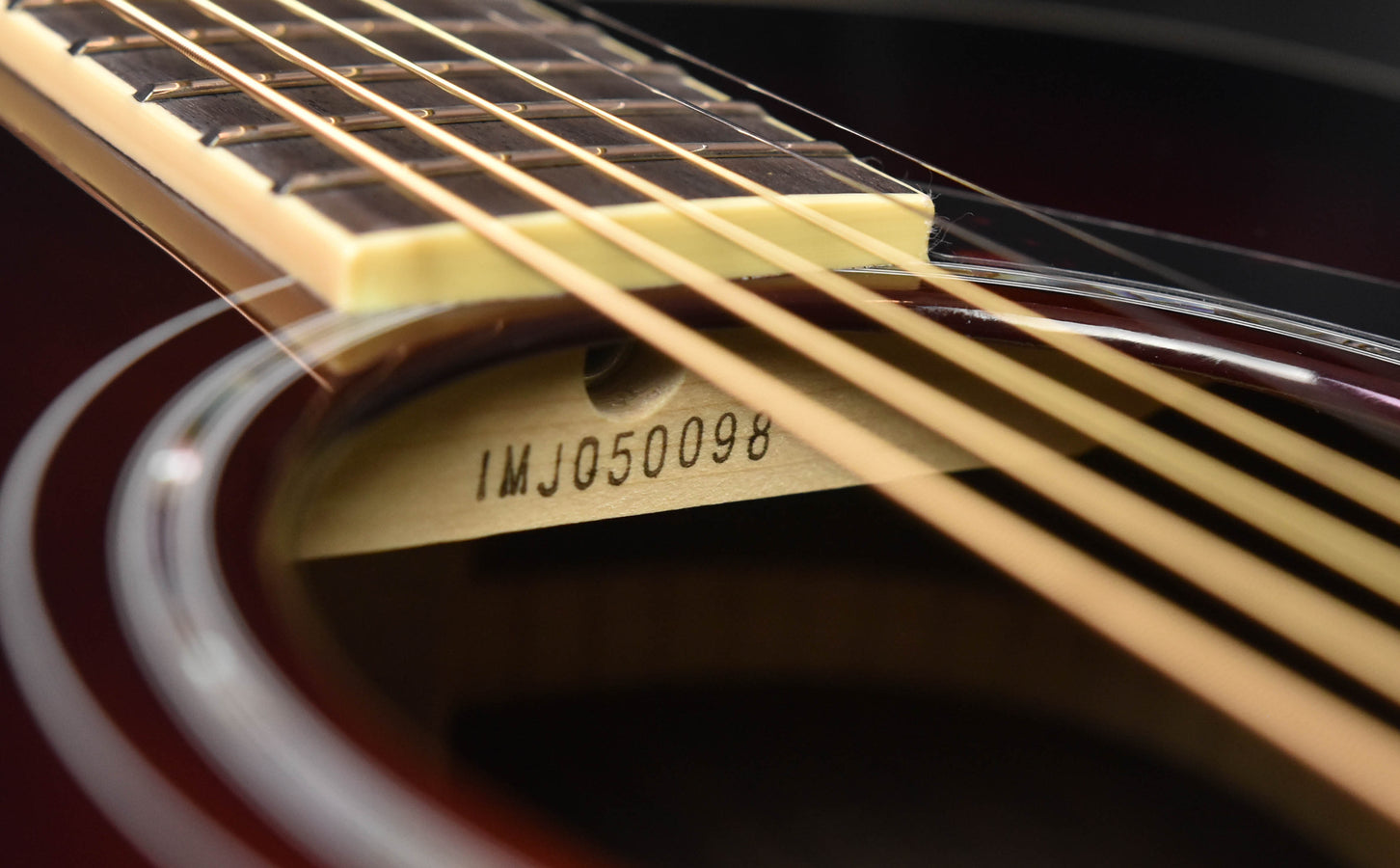 FS830 serial number IMJ0500098 on guitar neck near the strings