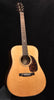 Acoustic dreadnought guitar with light wood top, tortoise-style pickguard, and rosette