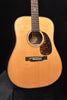 Acoustic dreadnought guitar, close front view: sound hole rosette and bridge area