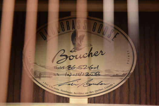 acoustic guitar interior label showing boucher model bg-52-gm and serial text