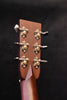 Acoustic guitar headstock rear view with six ornate tuning machines