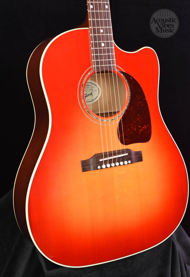Cherry burst acoustic guitar with soundhole and bridge pickups area