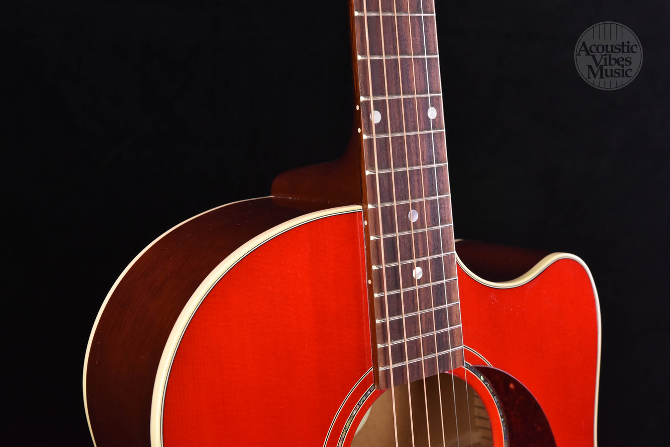 Cherry burst guitar neck and upper bout with soundhole rosette detail