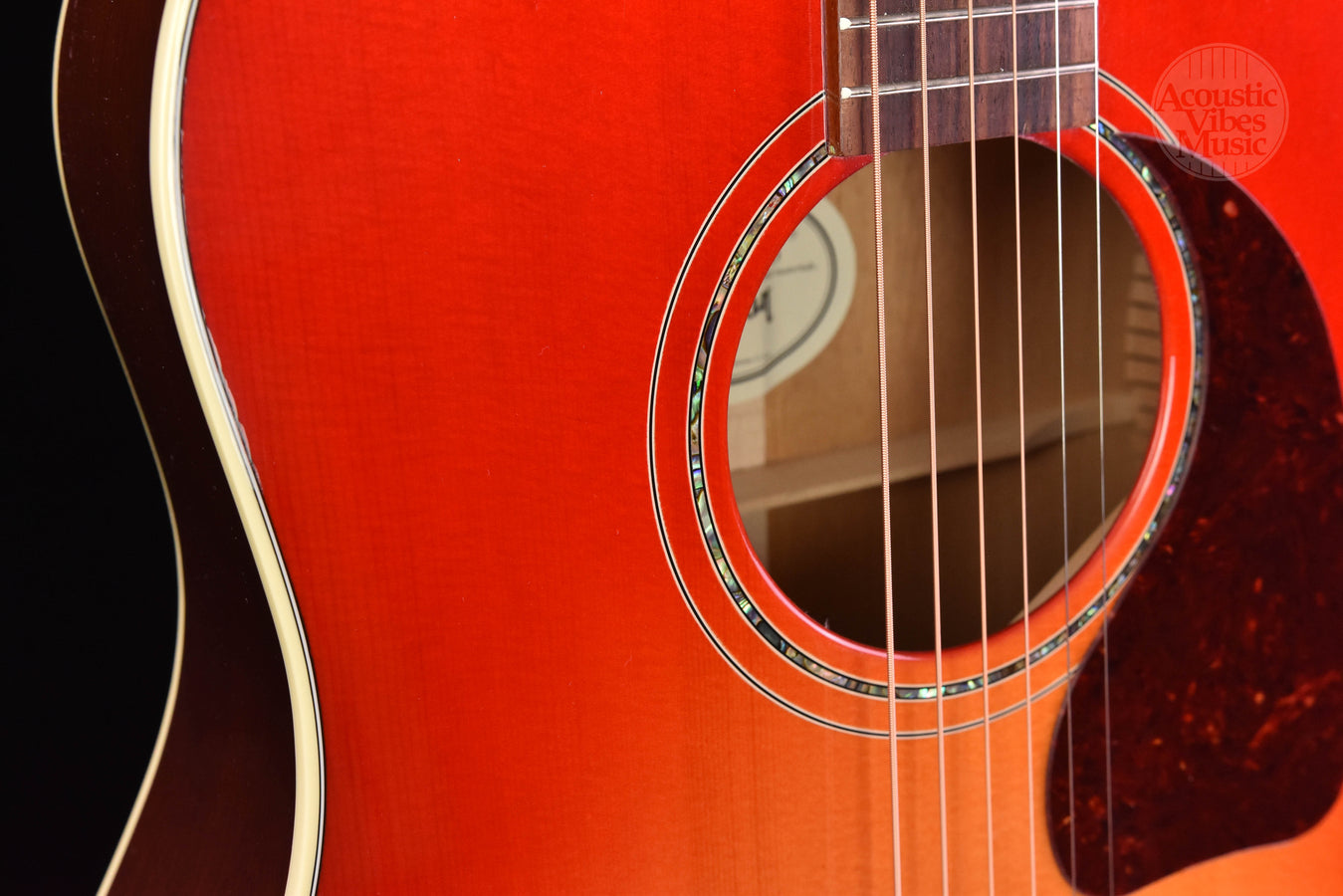 Soundhole close-up with multi-ring rosette on cherry burst guitar
