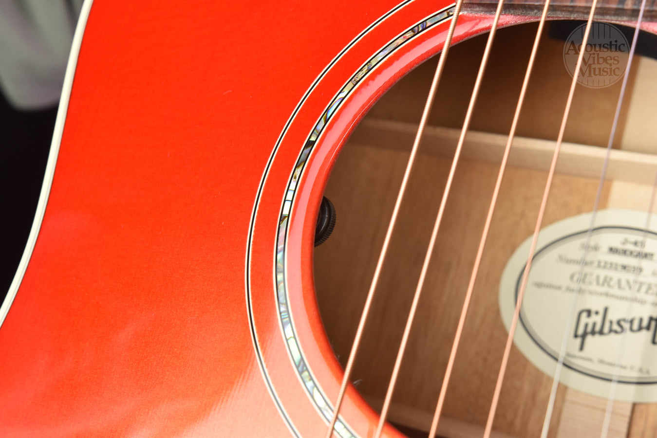 Side view of cherry burst guitar body with binding and soundhole