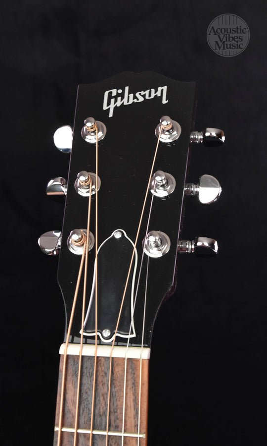 Headstock with Gibson logo and tuning machines on an acoustic guitar
