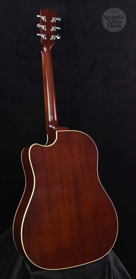 Mahogany acoustic guitar with glossy finish and gold-colored binding