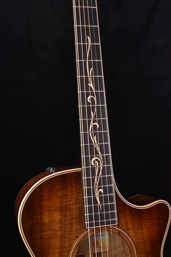 Koa acoustic guitar fretboard with decorative inlays and 12-fret V-Class profile