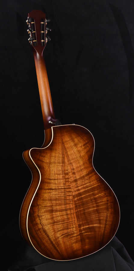 Taylor Koa acoustic guitar full body view with curved sides and cream binding