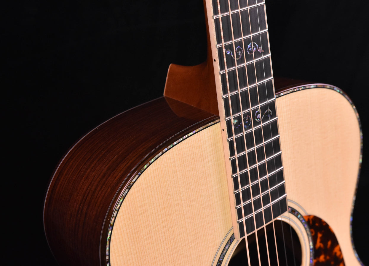 Acoustic guitar neck and fretboard, dark wood side and detailed binding
