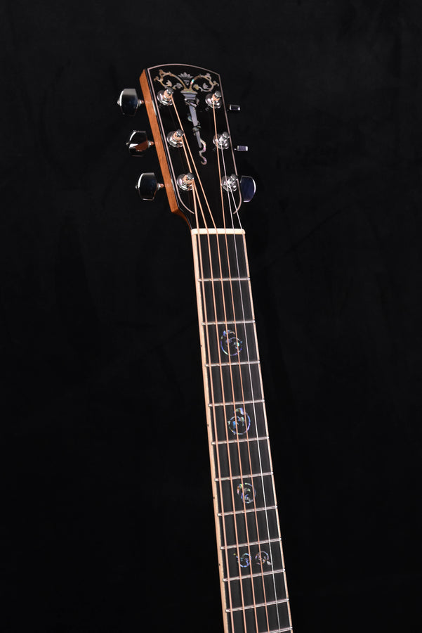 Guitar headstock with ornate inlay and chrome tuning machine pegs