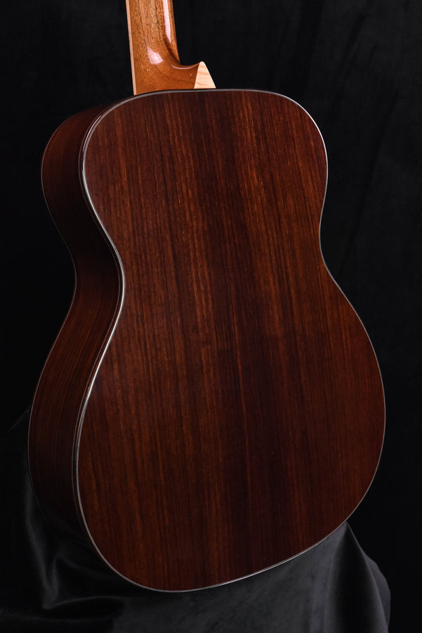 Acoustic guitar back close-up, dark wood grain and glossy clear coat