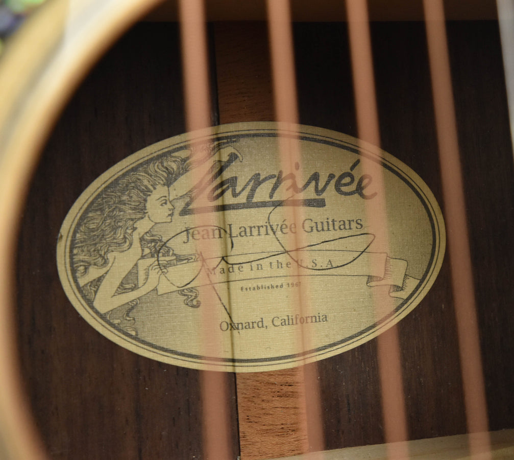 Used OM-10 guitar oval label reading Larrivée Jean Larrivée Guitars