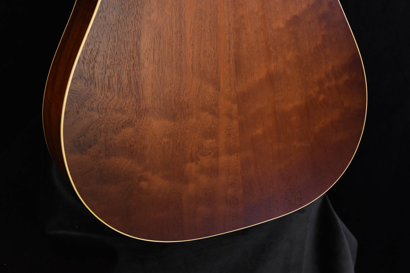 Guitar back with dark wood grain and cream outline binding