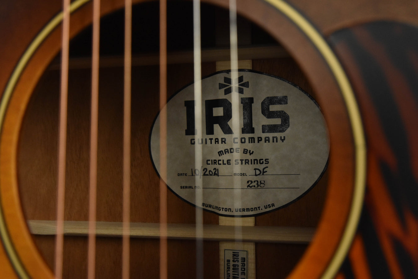 IRIS Circle Strings label on guitar top near sound hole