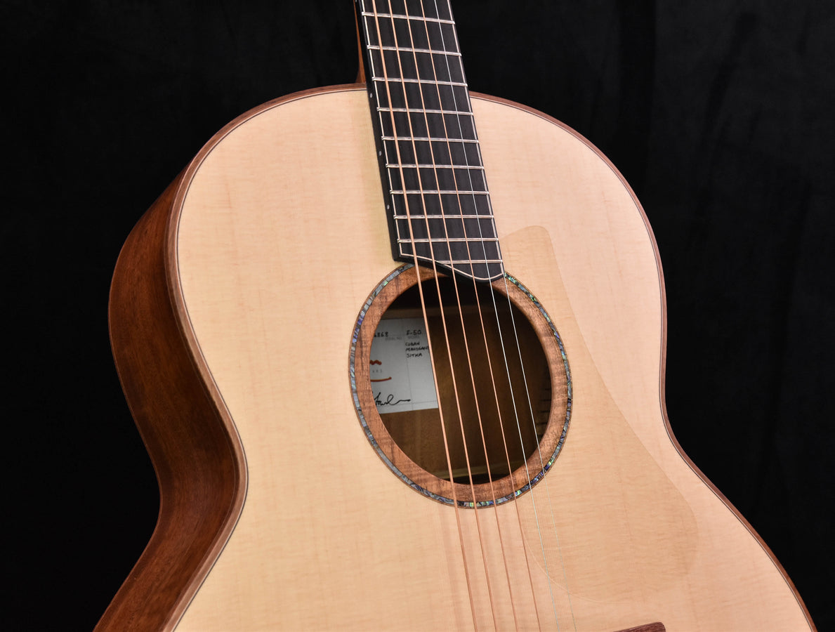 Lowden F50 soundhole close-up with bridge area and fretboard strings crossing