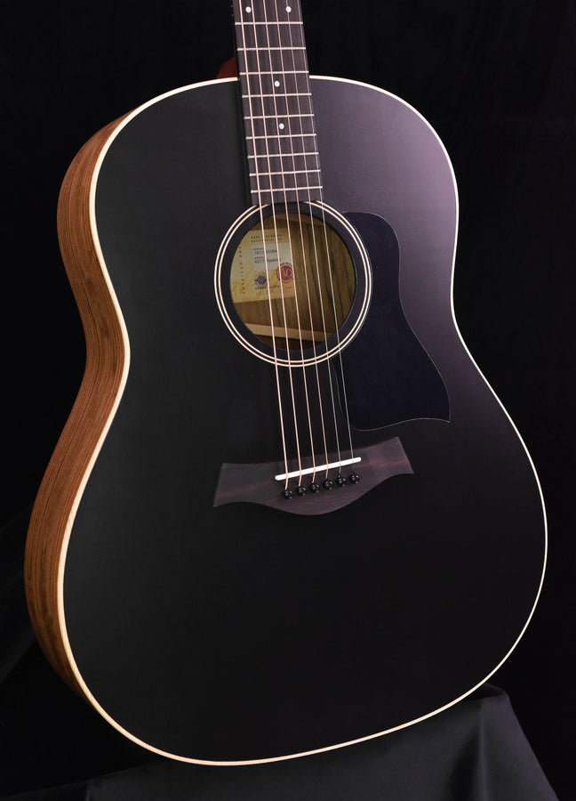 Blacktop guitar front close-up: circular soundhole, rosette, bridge and strings