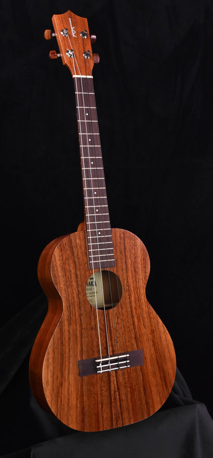 Kamaka HF-4 baritone ukulele with carved wooden body, sound hole, and dark fretboard