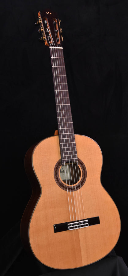 Cedar top classical guitar, front view with sound hole and fretboard