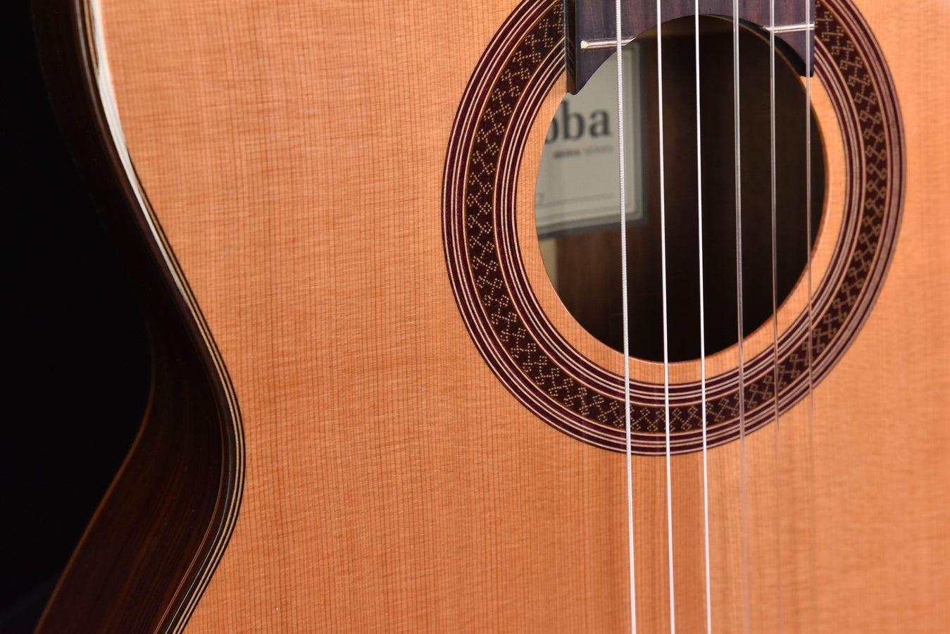 Cedar top classical guitar sound hole with decorative rosette and strings