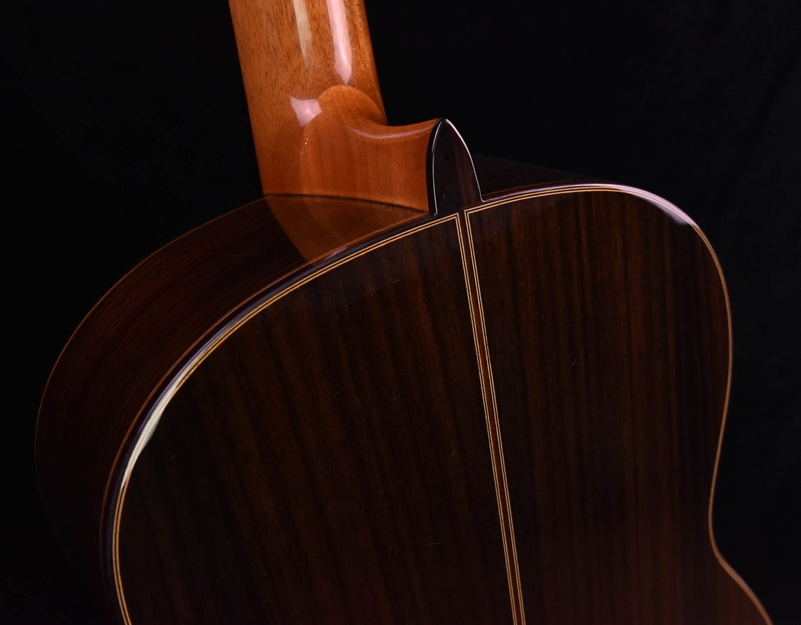 Cordoba C7 classical guitar top and rosette, close-up on light wood soundboard