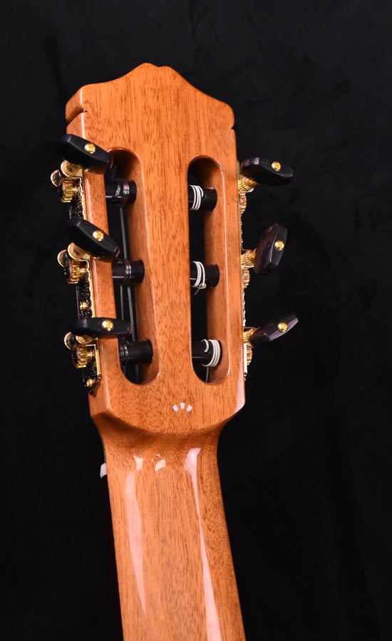 Classical guitar headstock with tuning pegs and headplate, light wood close-up