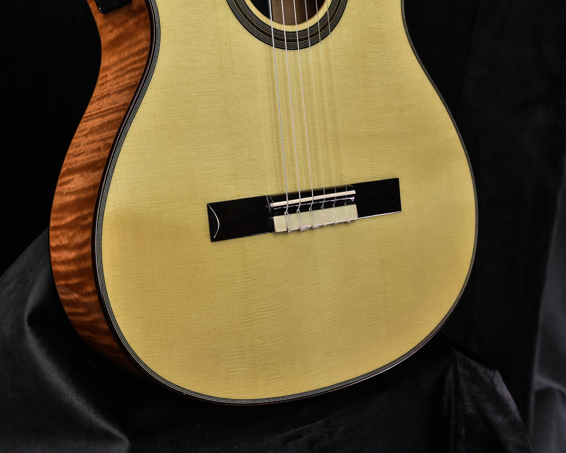 Cordoba Fusion 12 soundboard with black bridge and visible nylon strings