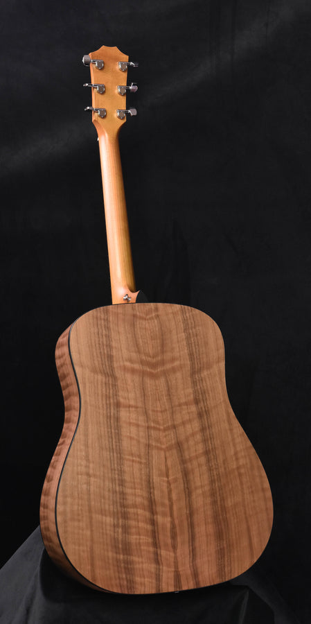 Back of acoustic guitar with warm wood grain in natural brown finish