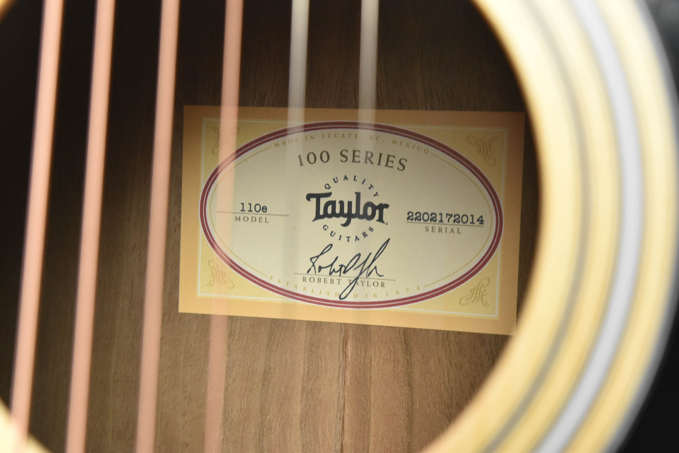 100 Series model label with “110E” text inside the guitar
