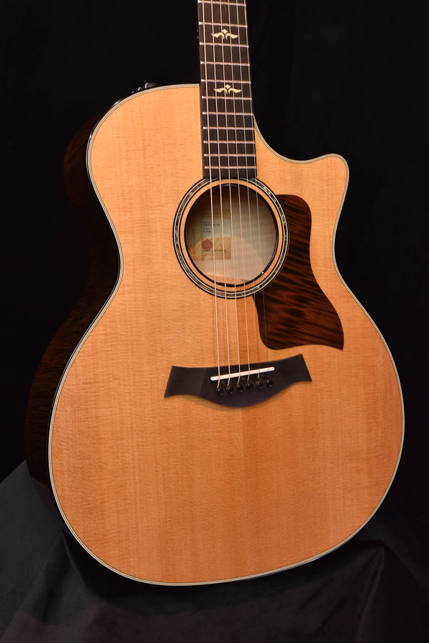 Natural acoustic guitar body with black pickguard and circular rosette soundhole