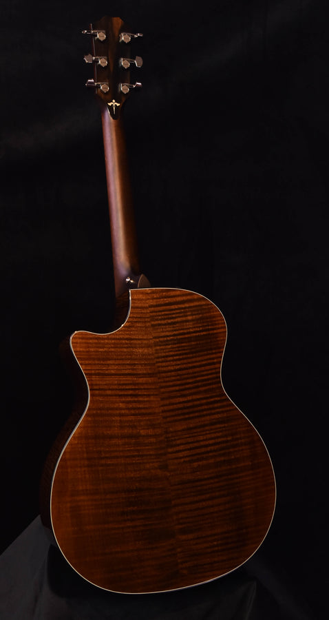 Acoustic guitar with dark wood-grain top and headstock with tuning pegs