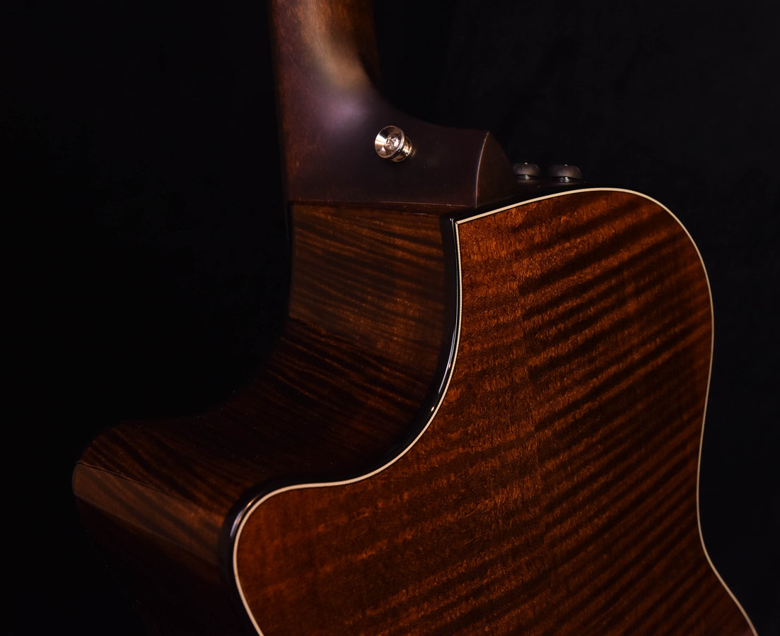 614CE V-Class soundboard close-up, warm brown finish with striped wood pattern