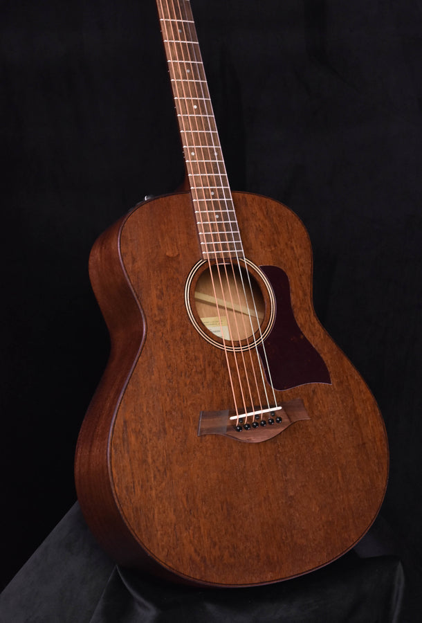 Mahogany grand theater acoustic guitar, close-up of sound hole and pickguard