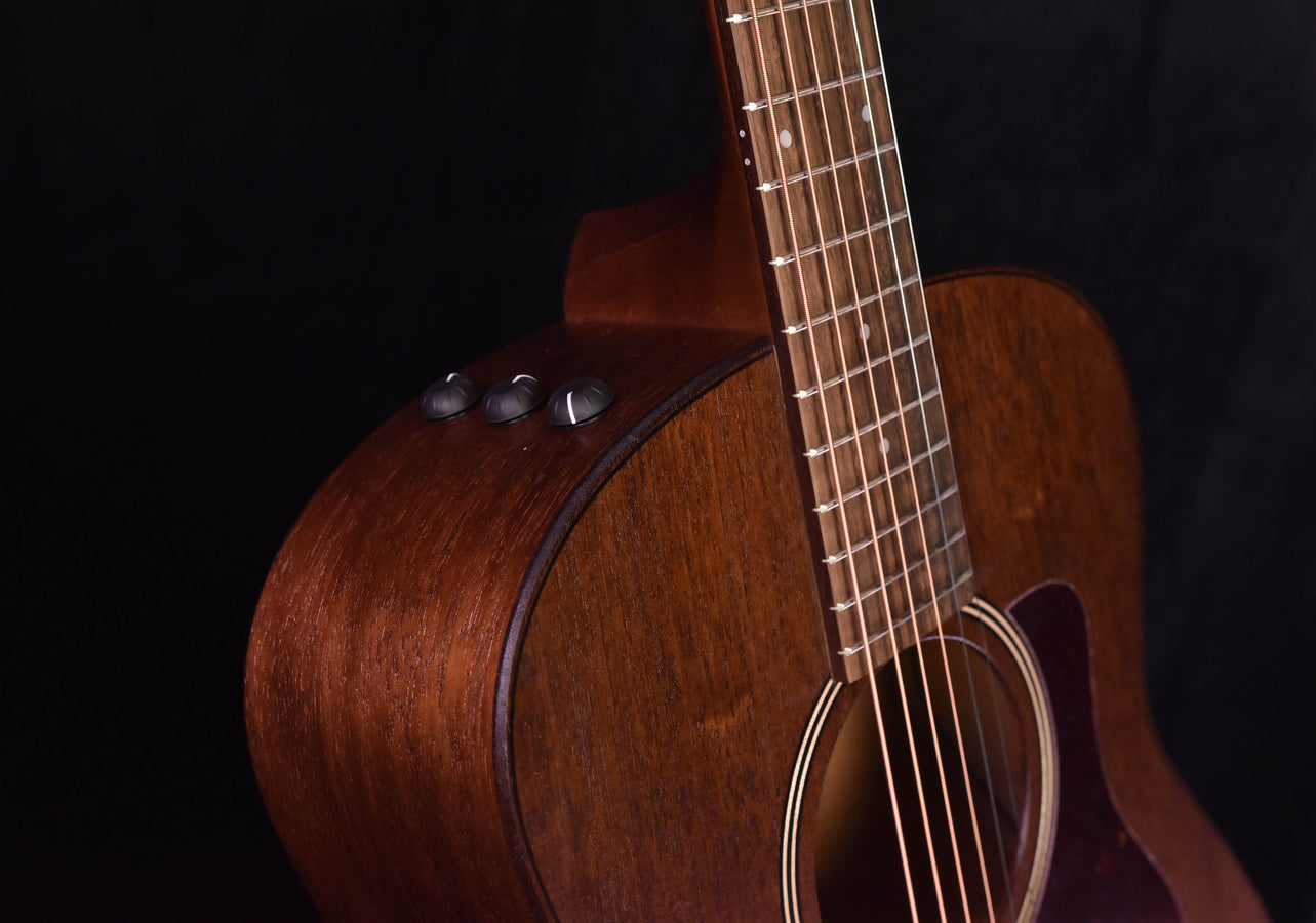 Mahogany grand theater acoustic guitar, side view of neck and fretboard