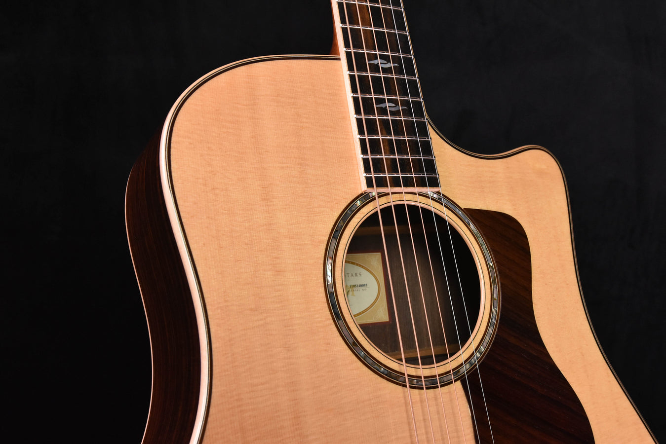 Used Taylor 810 CE guitar: sound hole rosette, fretboard edge, and natural top