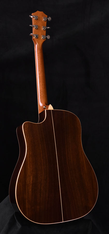 Used acoustic guitar with dark wood back and neck, top facing left, Taylor 810 CE